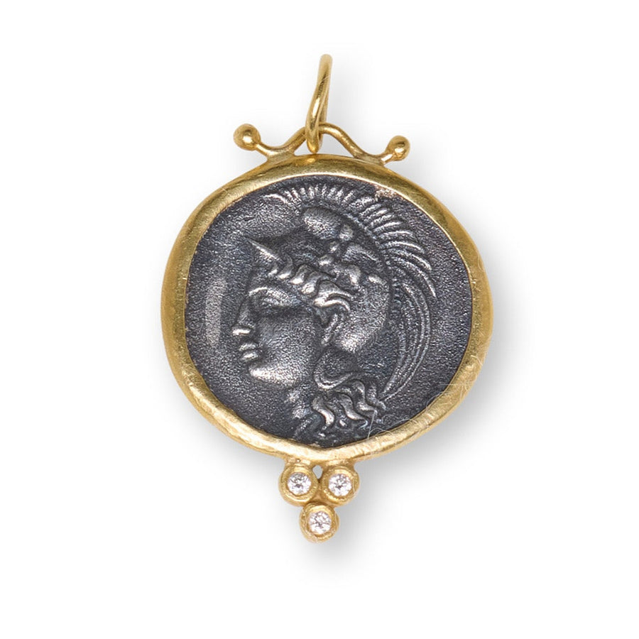 Medallion pendant with gold frame and stone on a white background
