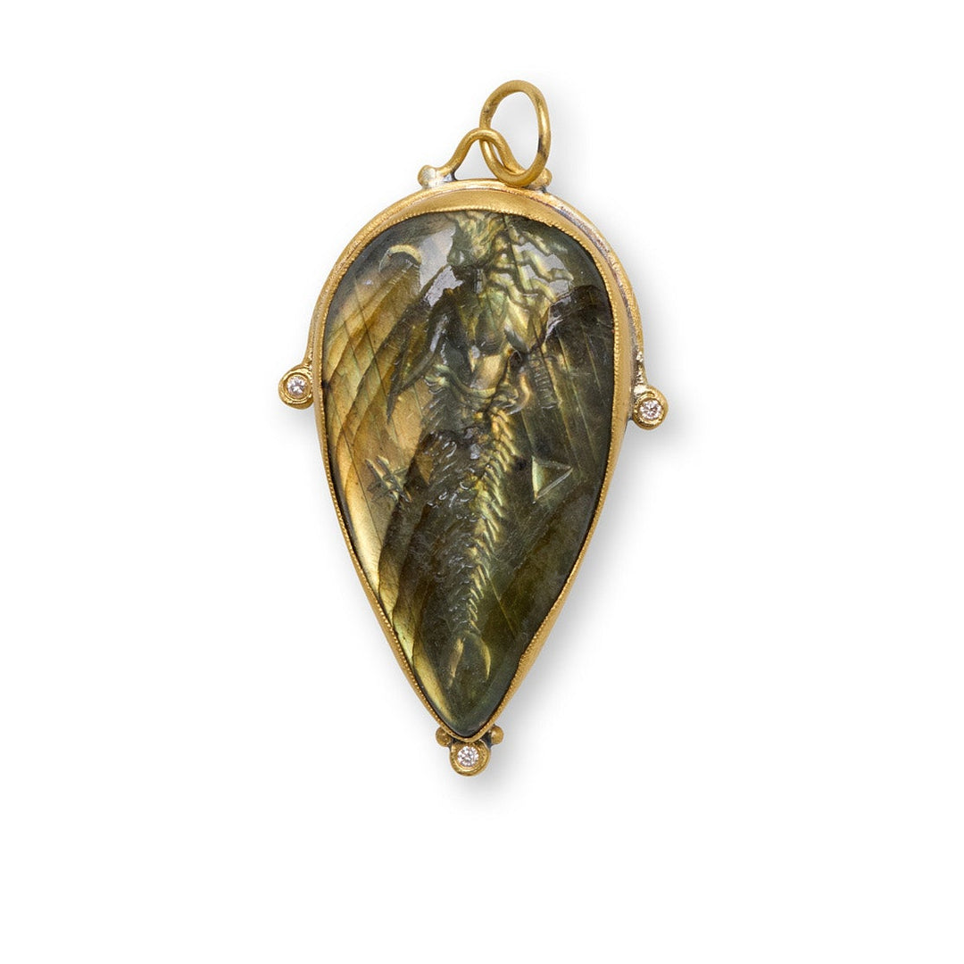 Gold pendant with a green stone on a white background