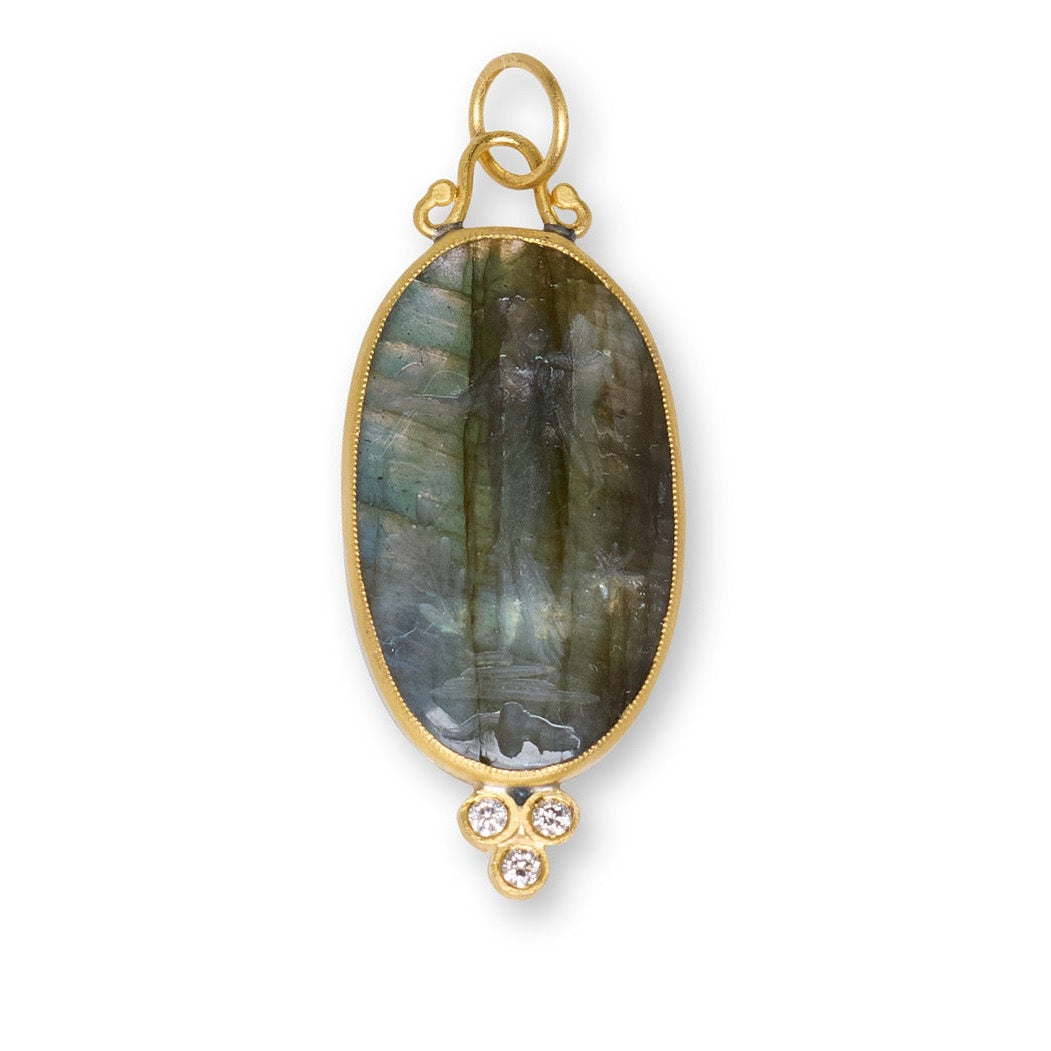 Gold pendant with a large labradorite stone on a white background