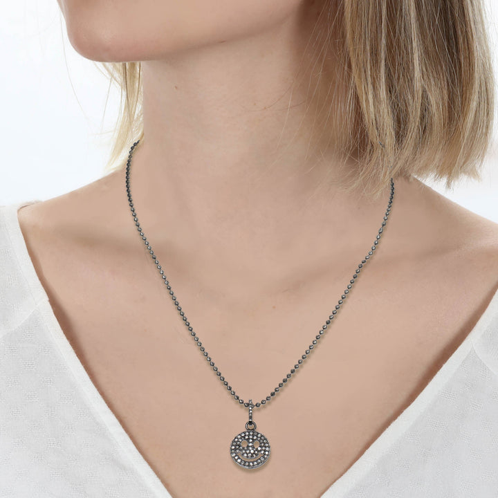 Necklace with a pendant worn by a model against a white background