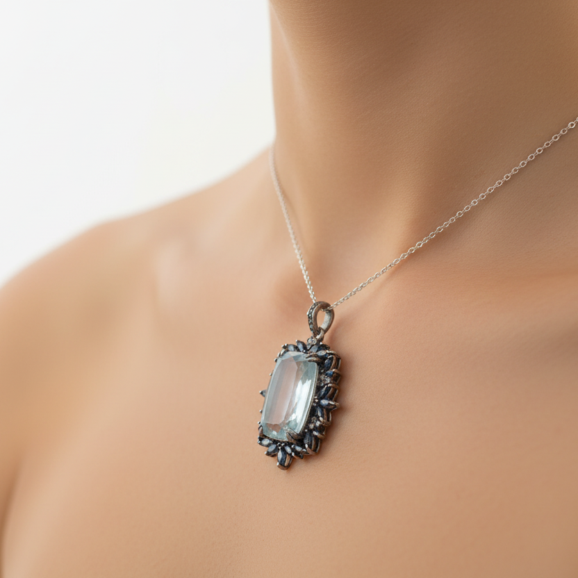 Pendant with a green stone and black accents on a beige fabric background