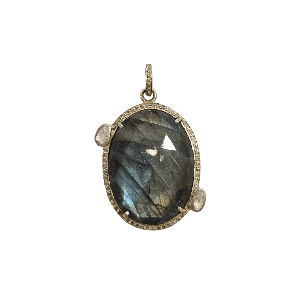 Labradorite pendant with silver frame on a textured beige background