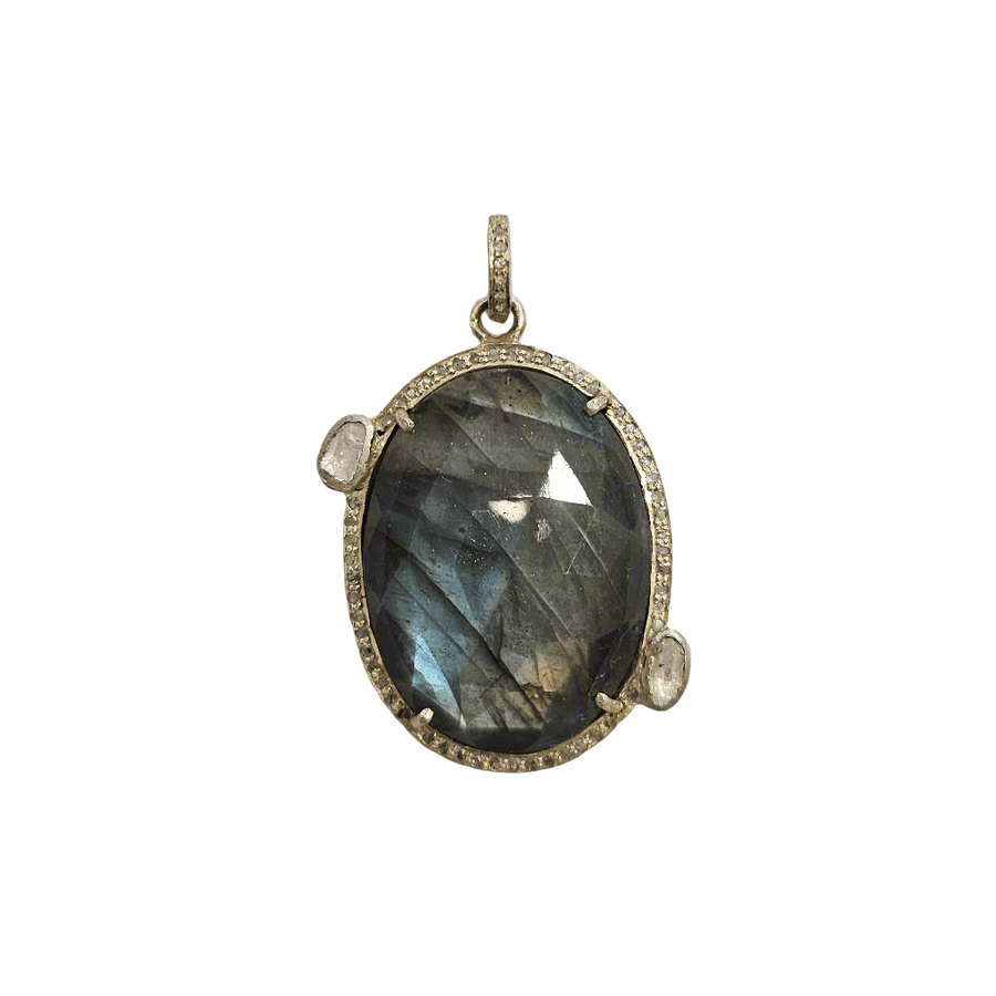 Labradorite pendant with silver frame on a textured beige background
