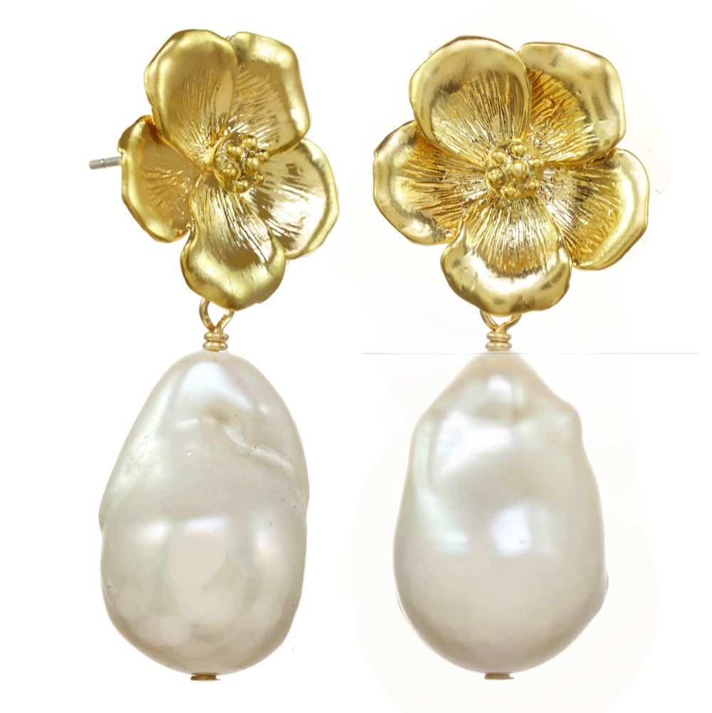 Gold flower-shaped earrings with pearl drops on a white background