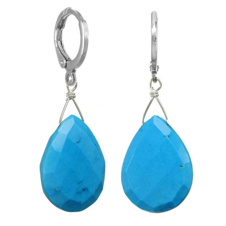 Pair of blue teardrop earrings with silver hooks on a white background
