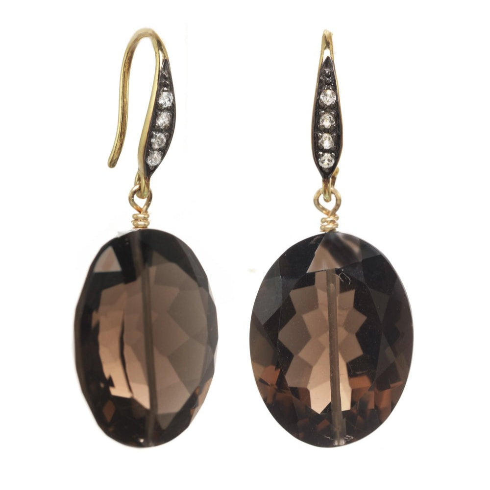 Pair of smoky brown oval earrings with gold hooks on a white background