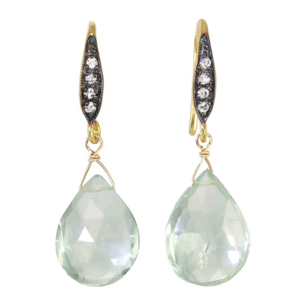 Pair of earrings with teardrop-shaped green gemstones and gold accents on a white background