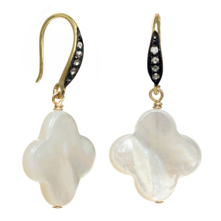 Pair of pearl earrings with gold and black accents on a white background