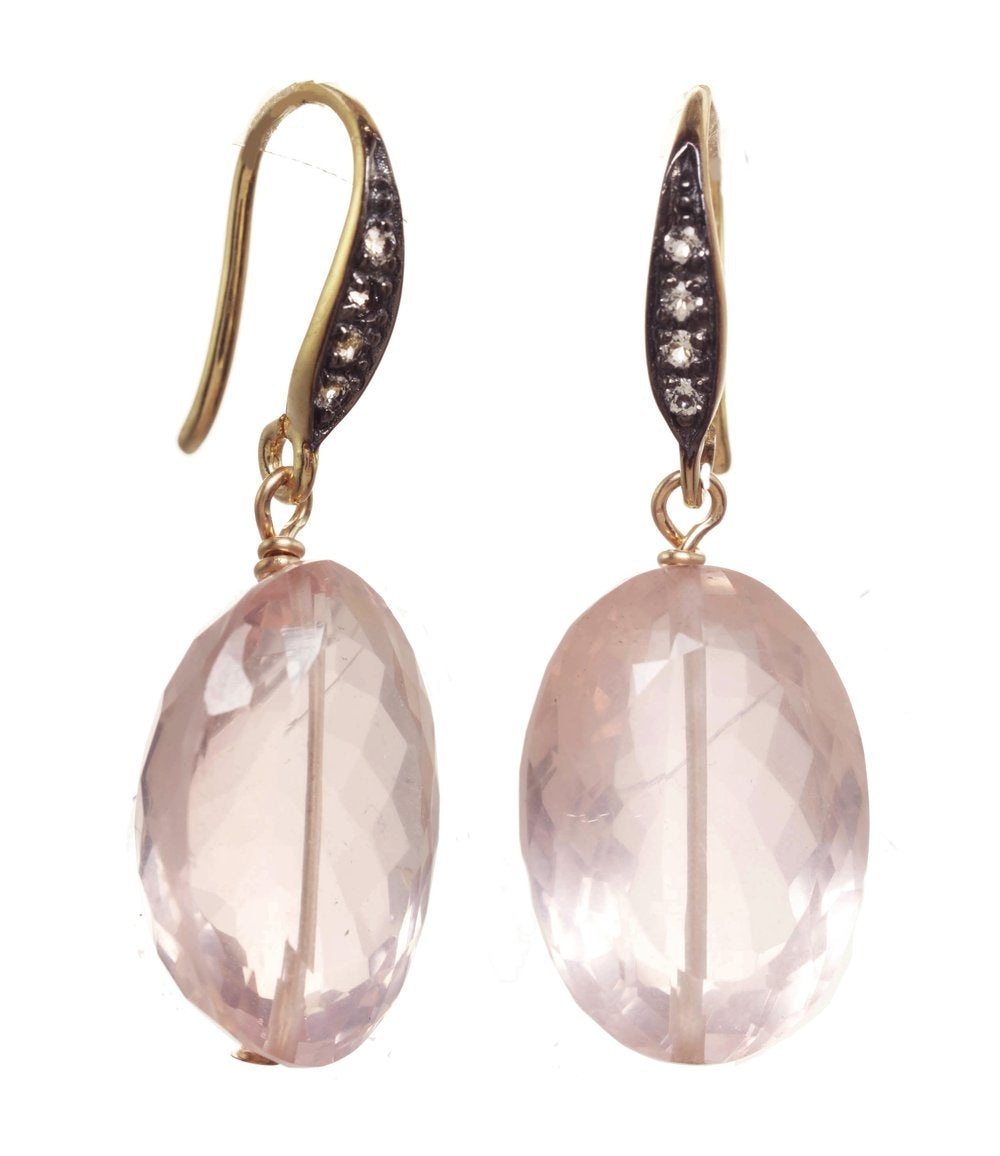 Pair of earrings with pink stones and gold accents on a white background