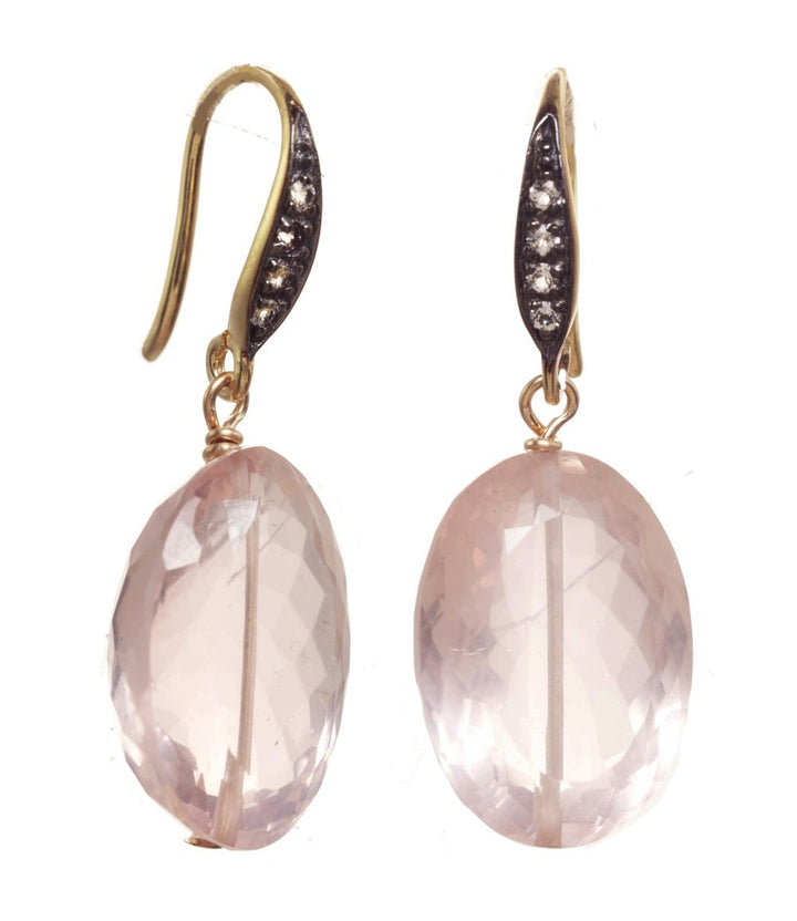 Pair of earrings with pink stones and gold accents on a white background