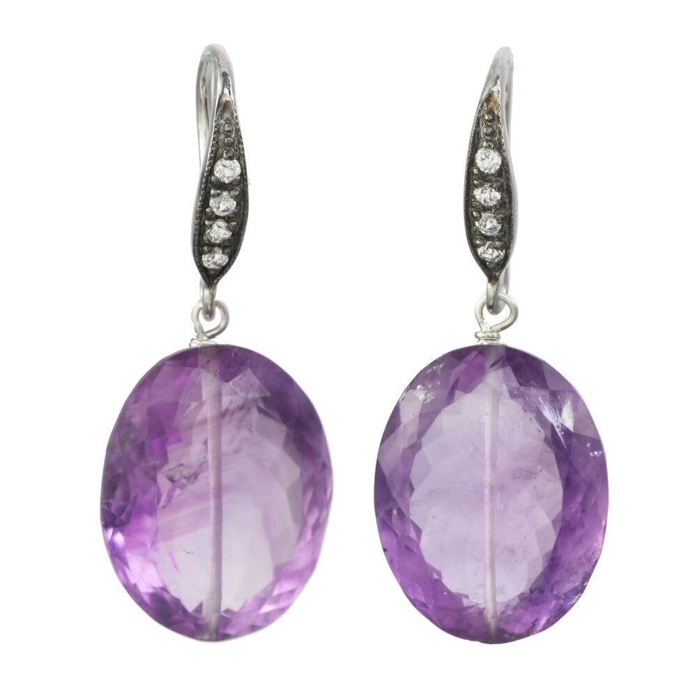 Pair of purple amethyst earrings with silver accents on a white background