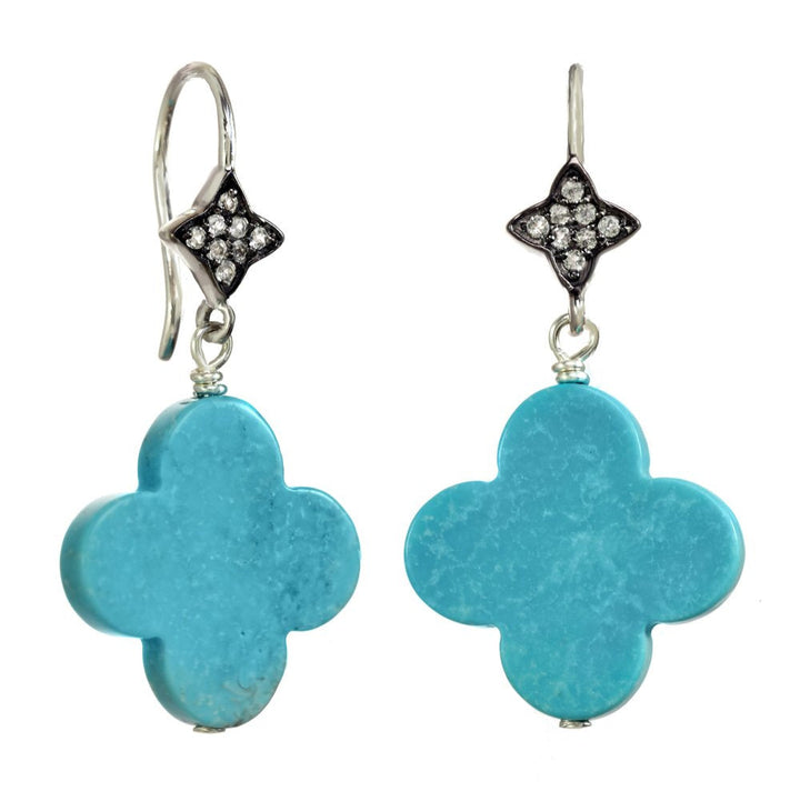 Turquoise quatrefoil earrings with diamond-studded tops on a white background