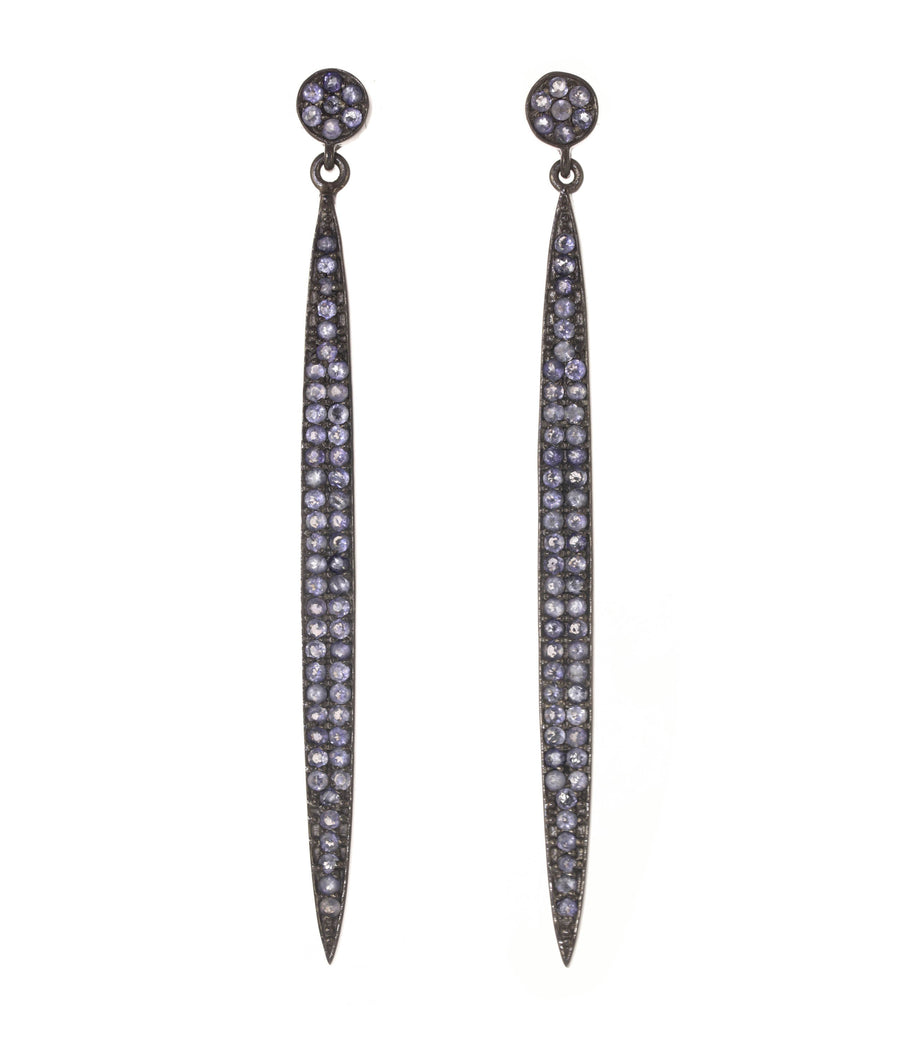 Pair of long, thin earrings with purple gemstones on a white background