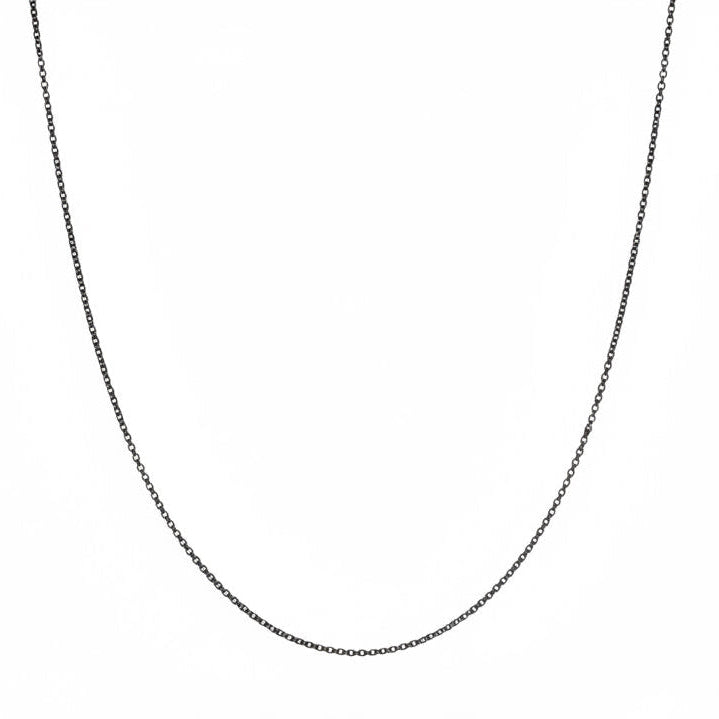 Black necklace on a mannequin with a white background