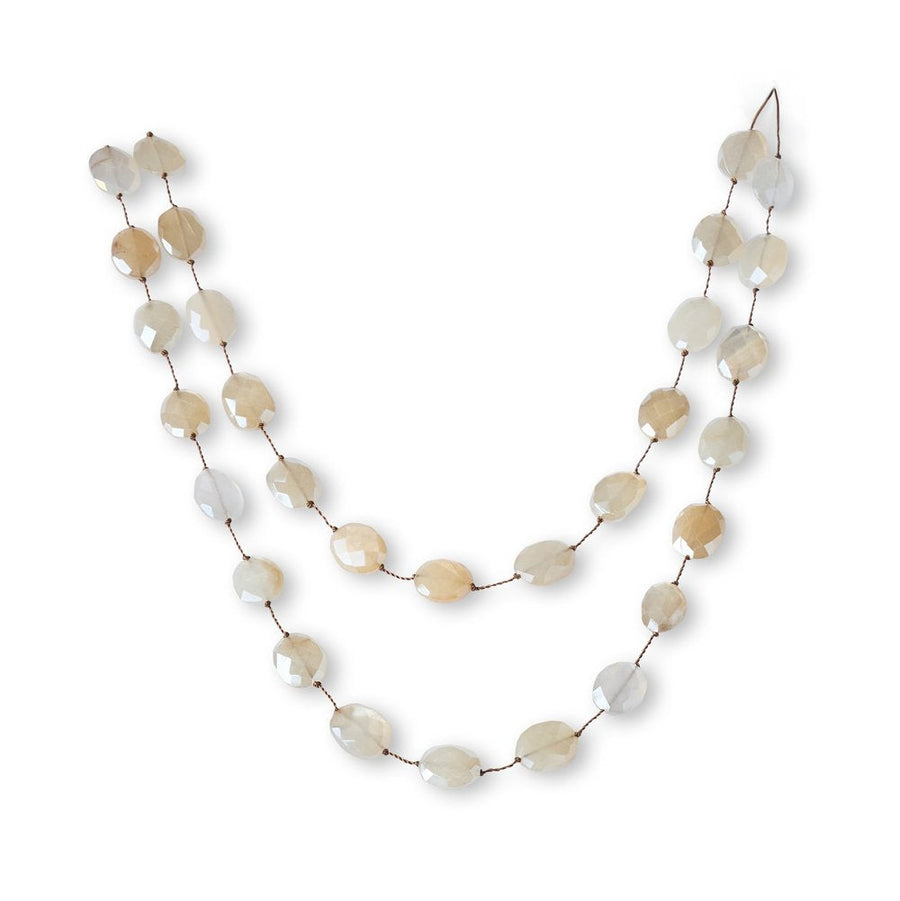 Necklace with beige and white beads on a white background