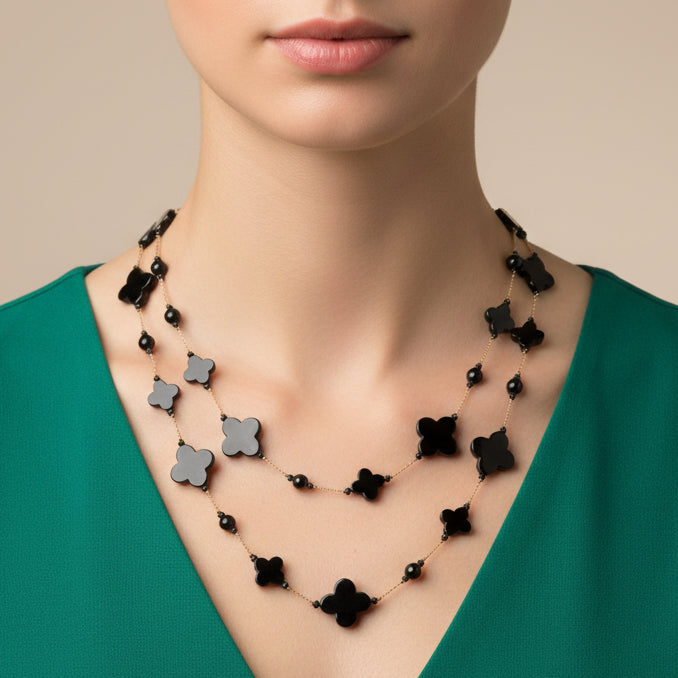 Black flower-shaped beaded necklace on a white background