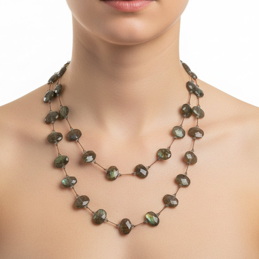 Necklace with green and brown beads on a white background
