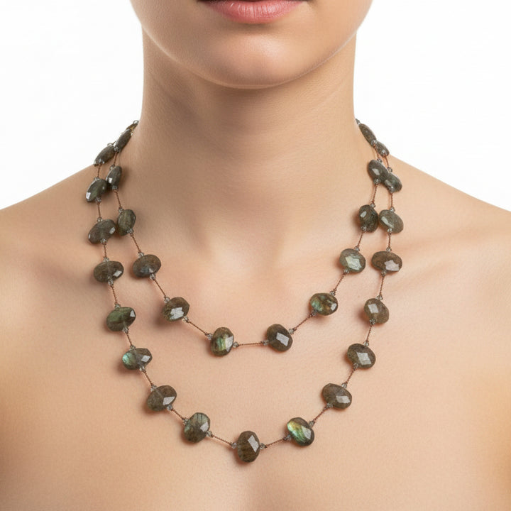 Necklace with green and brown beads on a white background