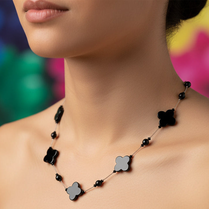 Black floral necklace on a white background