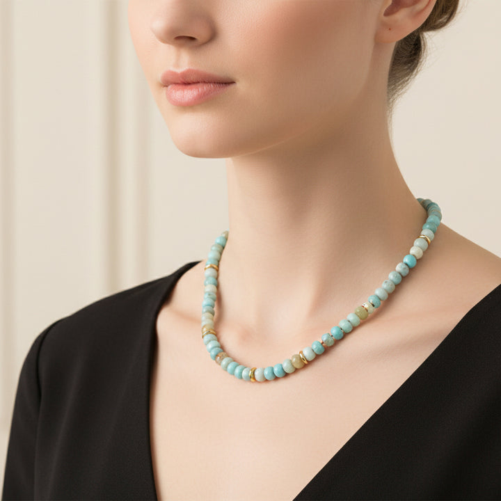 Necklace with blue and gold beads on a white background