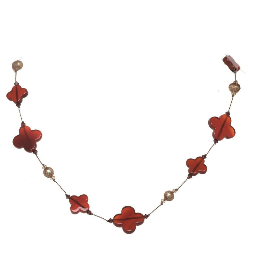 Necklace with red flower-shaped beads and gold accents on a white background