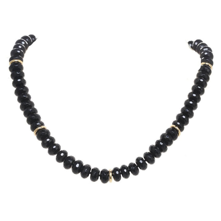 Black beaded necklace on a white background