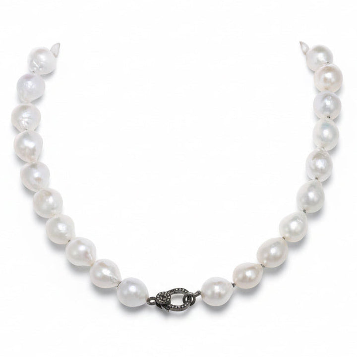 Pearl necklace with a clasp on a white background