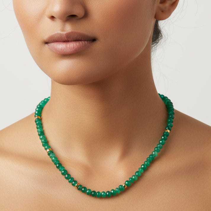 Green beaded necklace on a white background