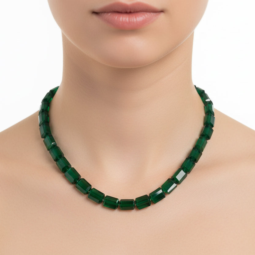 Green beaded necklace on a white background