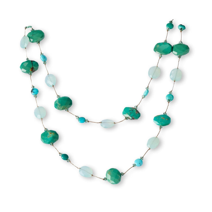 Necklace with green and blue beads on a white background