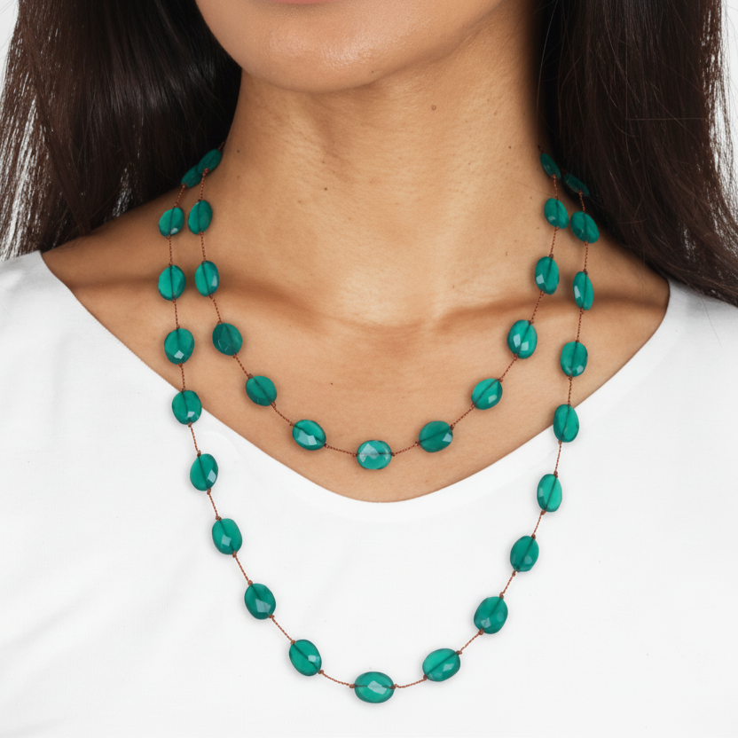 Turquoise beaded necklace worn by a person on a white background