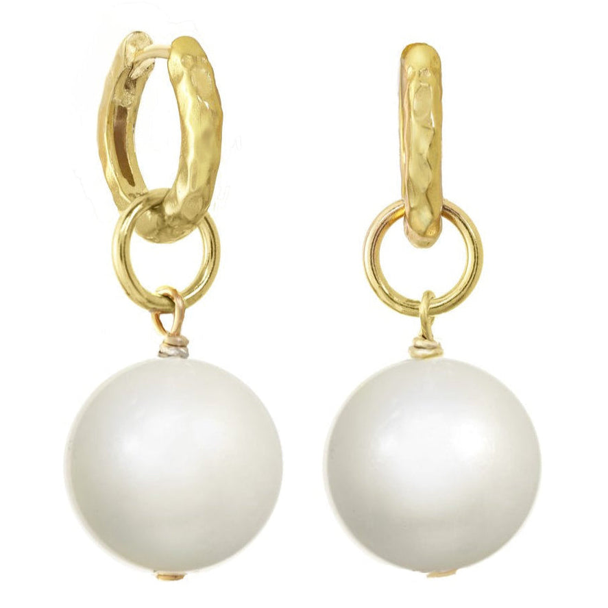 Gold hoop earrings with white pearls on a white background